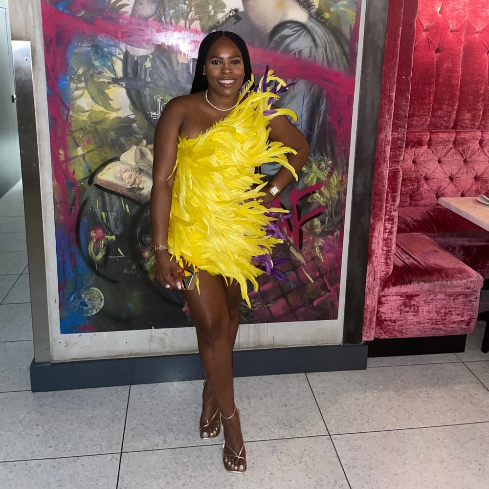 Super cute yellow with purple accent feather mini dress. Makes a statement.